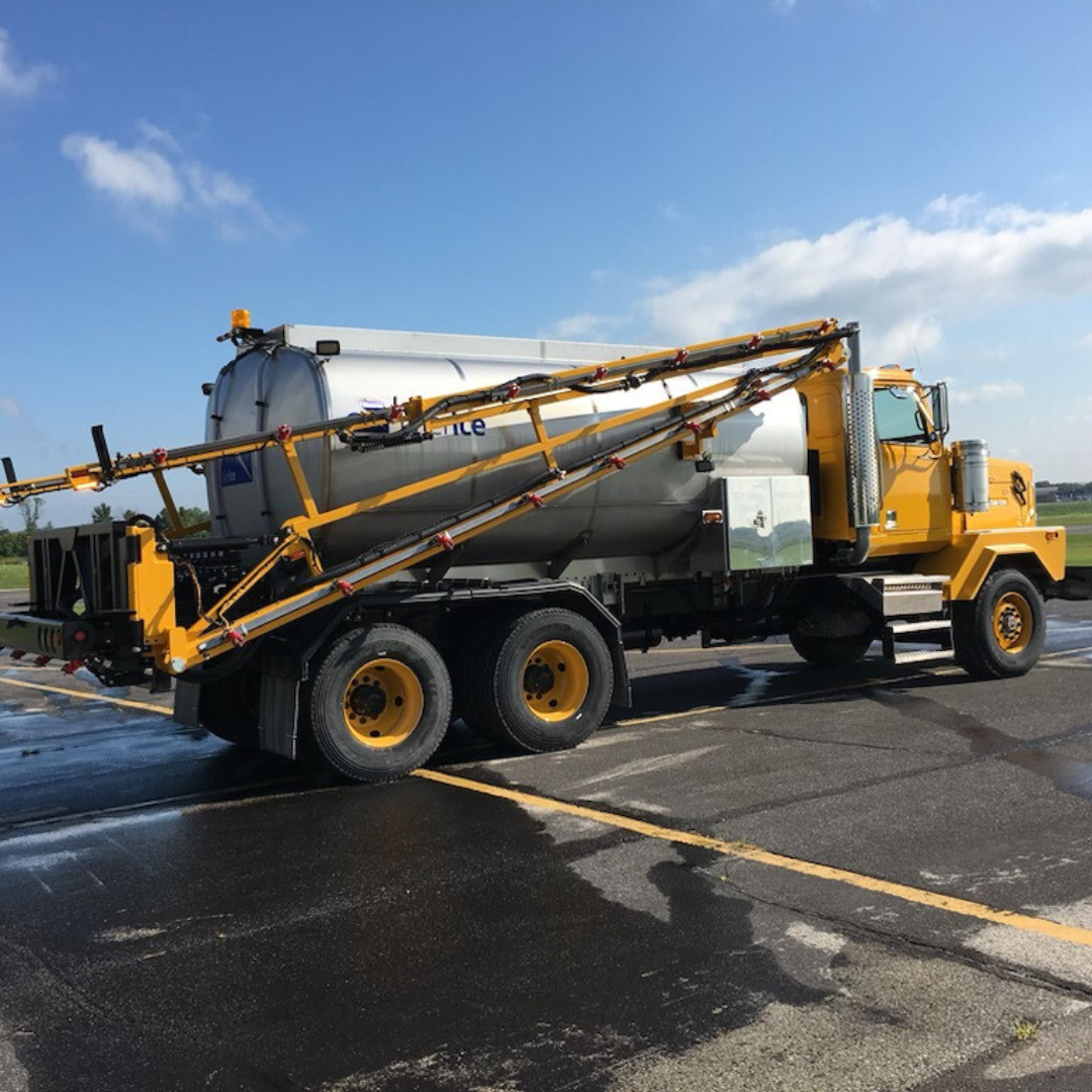 Tyler Ice 2000-Gallon Stainless Steel Deicing Trailer positioned on an airfield, equipped with 50-foot spray arms and color-coded pump station, designed for anti-icing and de-icing airport surfaces.