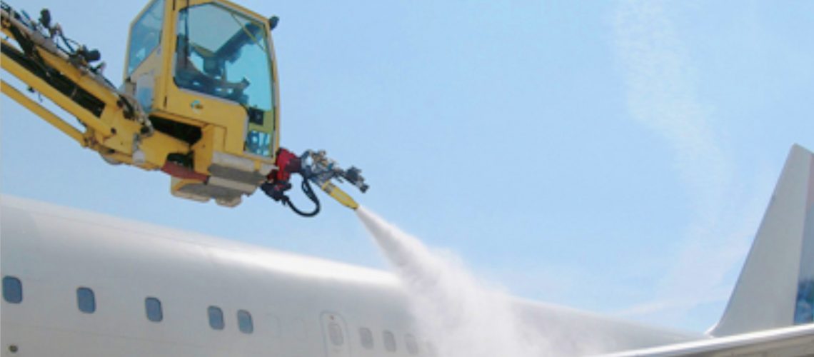 De-Icing machine de-icing the wings of a commercial airplane